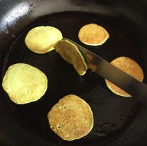 Turning fritters with a palette knife